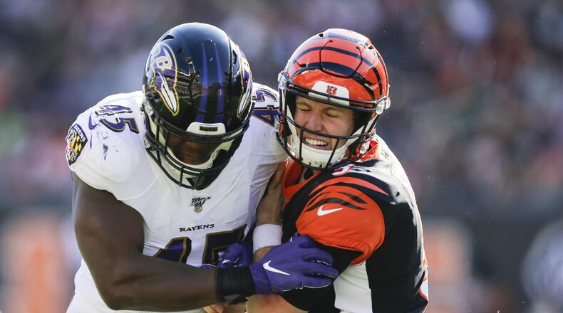 CINCINNATI, OHIO - NOVEMBER 10: Ryan Finley #5 of the Cincinnati Bengals is tackled by Jaylon Ferguson #45 of the Baltimore Ravens during the second quarter of the game at Paul Brown Stadium on November 10, 2019 in Cincinnati, Ohio. (Photo by Silas Walker/Getty Images)
