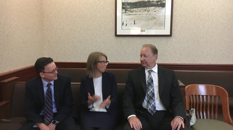 Fired Butler County Regional Airport manager Ron Davis sits with his attorneys Erin Heidrich and George Reul during a hearing in Common Pleas Judge Keith Spaeth’s courtroom. Davis has sued the county to get his $94,000 job back.