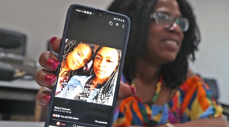 Stacy Cameron hold up her cellphone, showing a photo of her and her daughter Shauna Cameron, Wednesday, May 18, 2022. A Dayton man identified as a "strong" person of interest by police, Jamar Hayes, 26, was charged with murder on May 26 after Shauna was shot and killed May 8 while riding in a car along U.S. 35 in Riverside. BILL LACKEY/STAFF