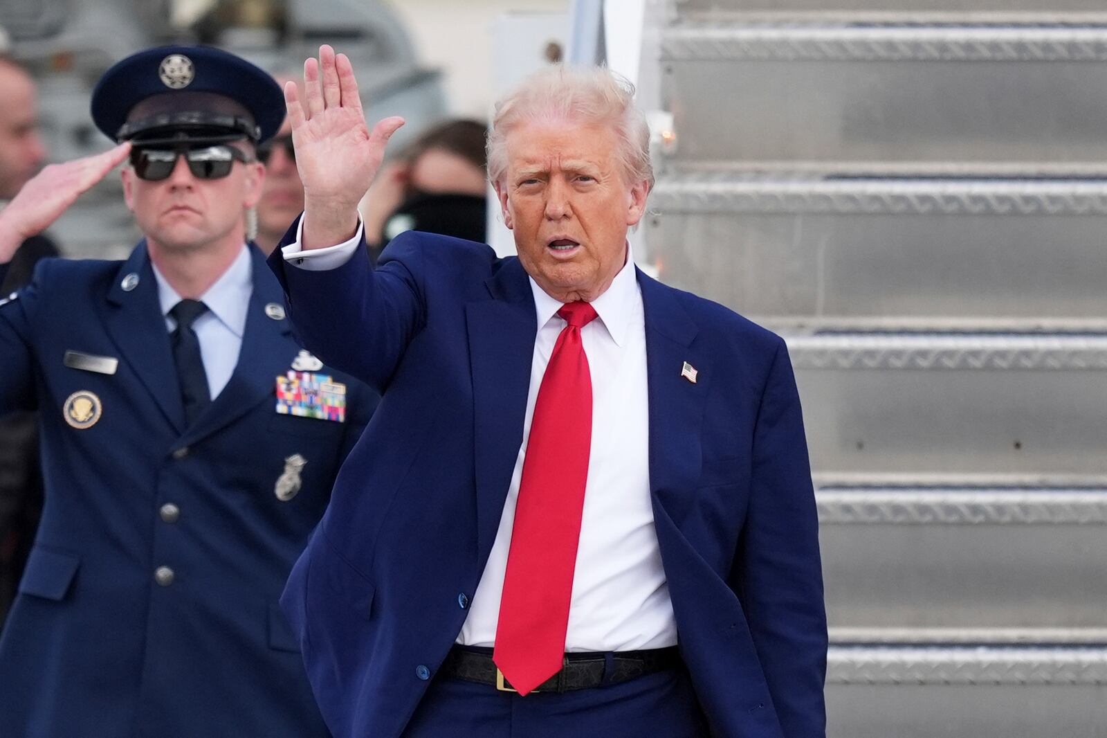 President Donald Trump waves as he arrives on Air Force One at Miami International Airport, Thursday, April 3, 2025, in Miami. (AP Photo/Rebecca Blackwell)