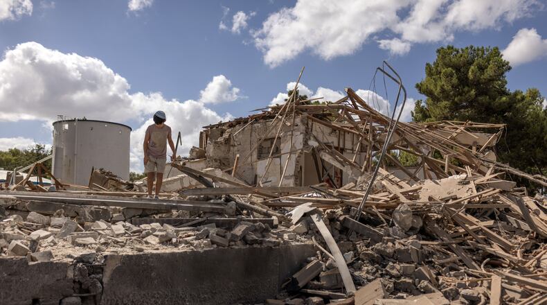 EDS.: RETRANSMISSION TO CORRECT SPELLING OF PHOTOGRAPHER’S NAME IN METADATA — A boy on Wednesday, Oct. 2, 2024, surveys the wreckage of a building that was destroyed by an Iranian missile attack in Hod Hasharon, near Tel Aviv, Israel. Israeli forces and Hezbollah said they were fighting at close range in southern Lebanon on Wednesday, a day after Prime Minister Benjamin Netanyahu vowed to retaliate against Iran for firing ballistic missiles at Israel in an attack that has further set the region on edge. (Avishag Shaar-Yashuv/The New York Times)