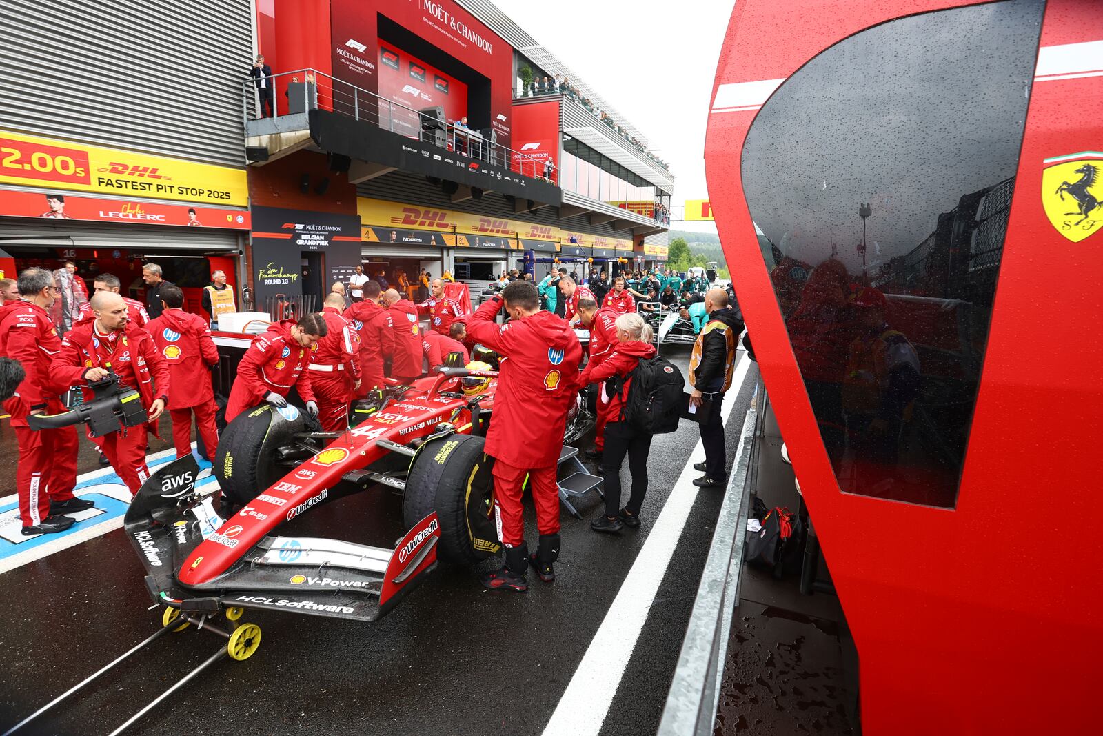 Crew work on the car of Ferrari driver Lewis Hamilton of Britain prior to the start of the Formula One Grand Prix at the Spa-Francorchamps racetrack in Spa, Belgium, Sunday, July 27, 2025. (Yves Herman, Pool Photo via AP)