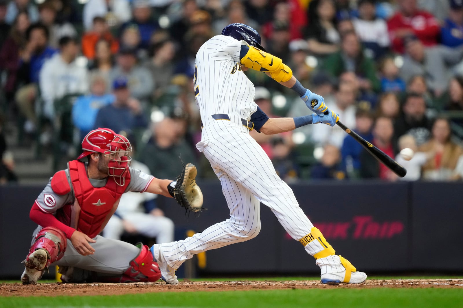 Milwaukee Brewers' Christian Yelich hits an RBI single during the third inning of a baseball game against the Cincinnati Reds, Sunday, April 6, 2025, in Milwaukee. (AP Photo/Aaron Gash)