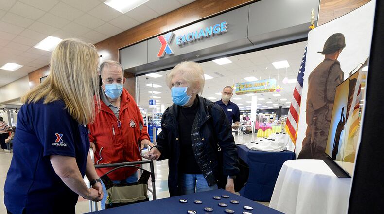 Sandra Church, acting store manager at the Base Exchange, chats with Air Force veteran Forrest Kerns and his wife, Phyllis, at Wright-Patterson Air Force Base on March 29. As part of National Vietnam War Veterans Day, Exchange managers presented Vietnam veterans with lapel pins and buttons to recognize, thank and honor those who served as they entered the store. U.S. AIR FORCE PHOTO/TY GREENLEES