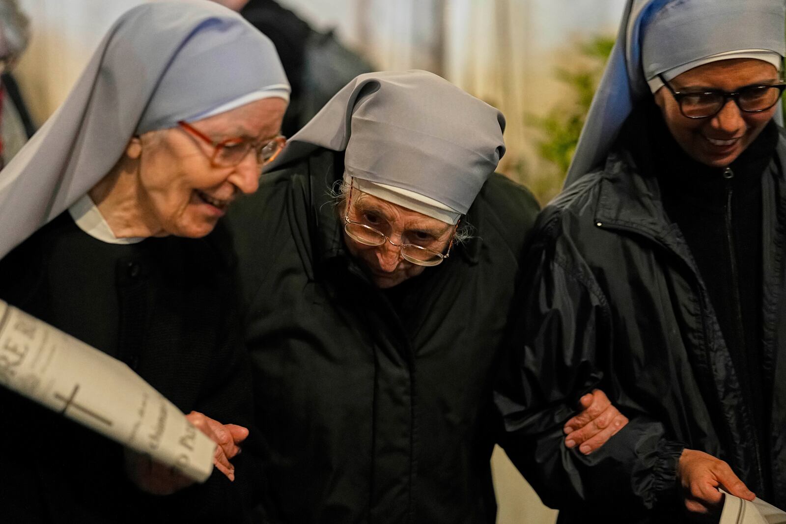 Nuns support each other as they leave after attending a rosary prayer outside the Santa Maria Maggiore Basilica, where the late Pope Francis will be buried, in Rome, Thursday, April 24, 2025. (AP Photo/Andreea Alexandru)