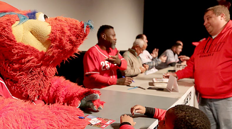 Ricky Brown, 5, gets an autograph from Gapper as his father, Chris Brown, speaks with Dmitri Young as the Reds Caravan made a stop at Miami University’s Hamilton campus Staurday, Jan. 28, 2017. Contributed Photo / E.L. Hubbard
