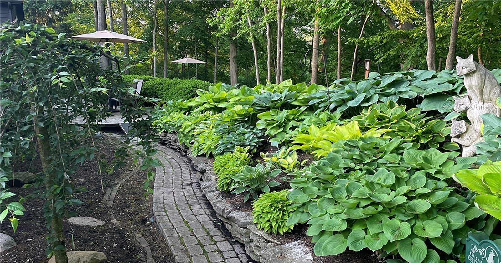 The back of the home features a heavily landscaped yard with paver walkways and patios. CONTRIBUTED