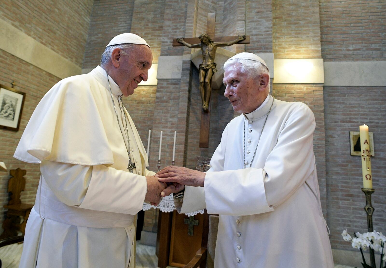 FILE - Pope Francis, left, embraces Emeritus Pope Benedict XVI, at the Vatican, June 28, 2017. (L'Osservatore Romano/Pool Photo via AP, File)