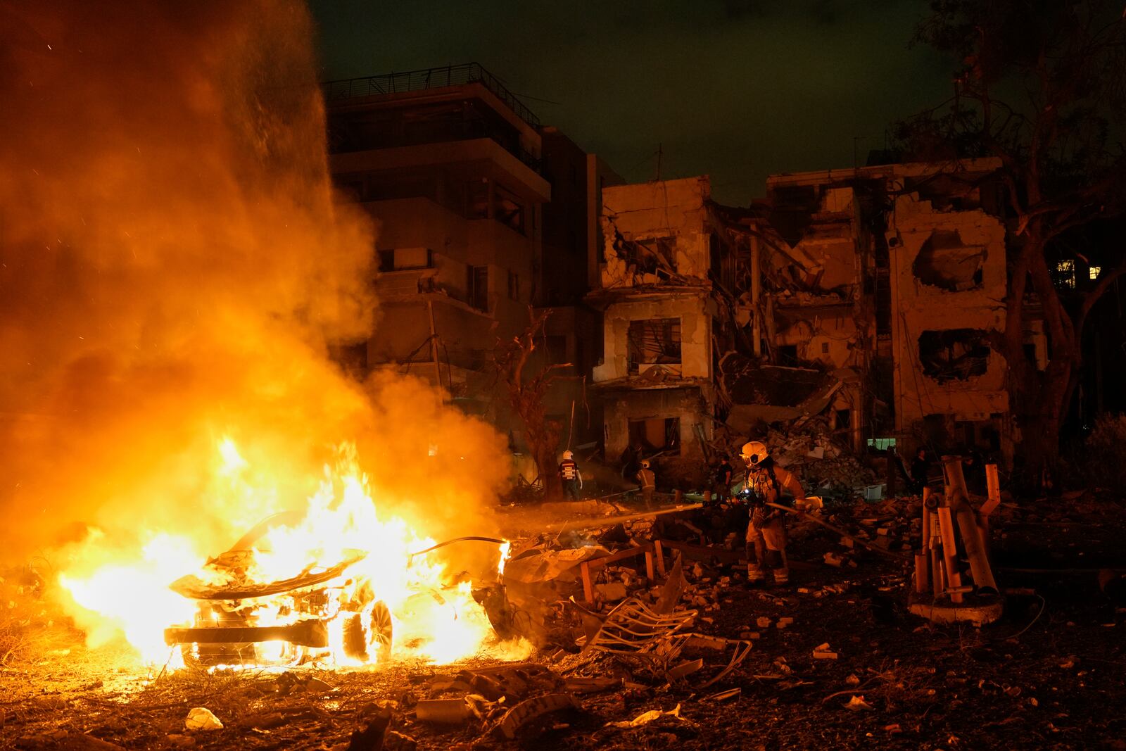 Firefighters work to extinguish a blaze after a missile launched from Iran struck Tel Aviv, Israel, Monday, June 16, 2025. (AP Photo/Baz Ratner)