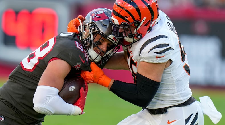 Tampa Bay Buccaneers tight end Cade Otton (88) is stopped by Cincinnati Bengals linebacker Logan Wilson (55) during the first half of an NFL football game, Sunday, Dec. 18, 2022, in Tampa, Fla. (AP Photo/Chris O'Meara)