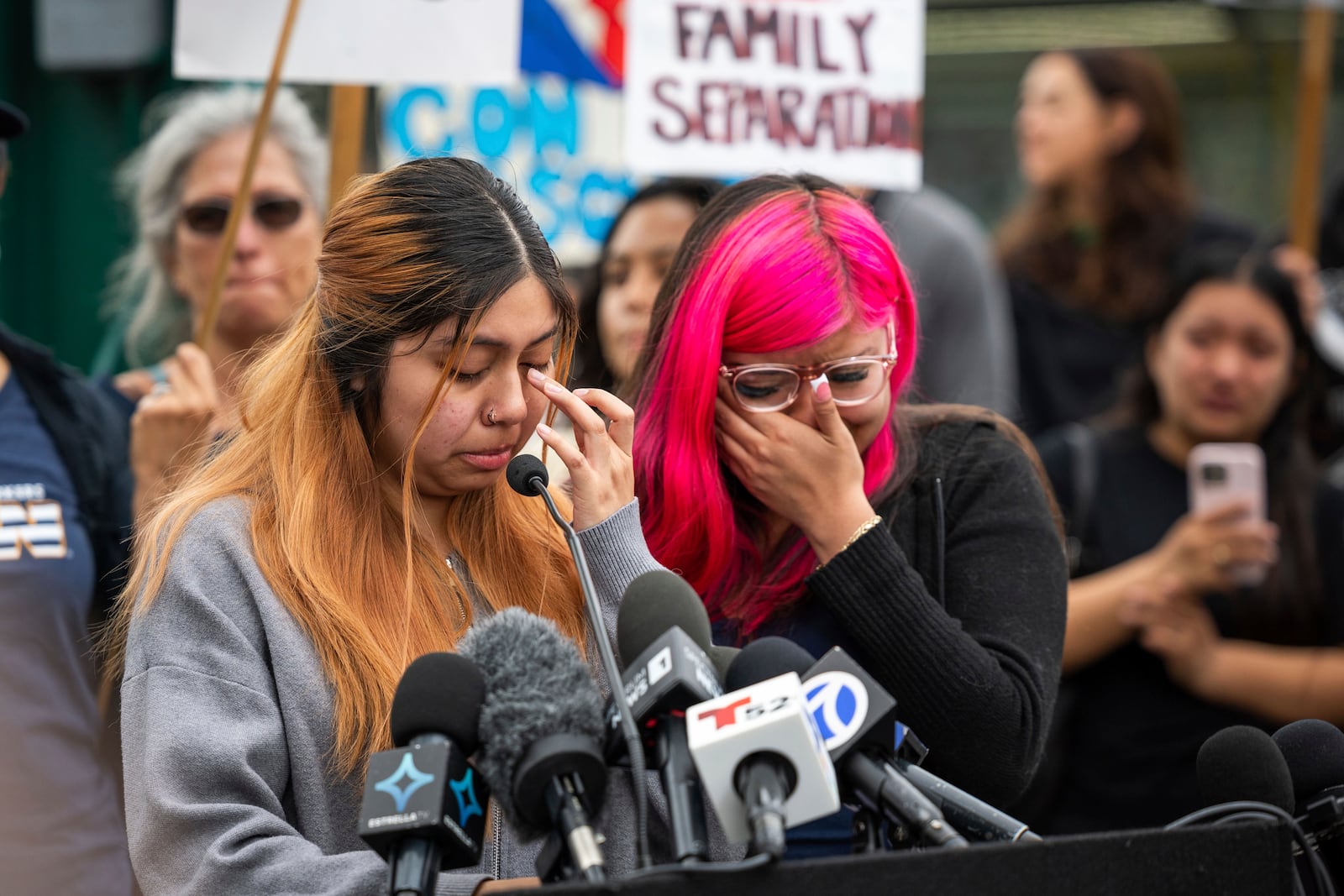Kimberly Hernandez and her sister Jaslyn Hernandez, daughters of a car wash worker, speak during a press conference with families of detained car wash workers, Wednesday, June 11, 2025, in Culver City, Calif. (AP Photo/Ethan Swope)