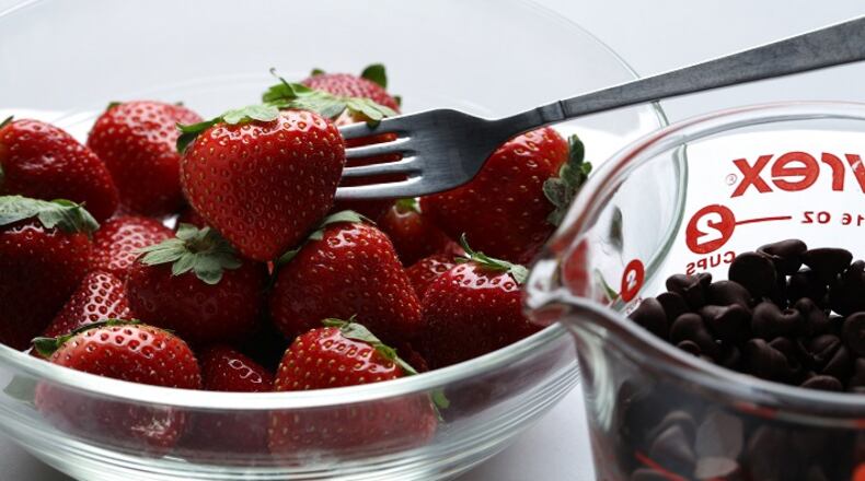 Don't forget dessert, but keep it simple. You don't need to make a flourless chocolate cake, says cookbook author Heather Christo. Just melt some chocolate to serve over fresh berries. (E. Jason Wambsgans/Chicago Tribune/TNS)