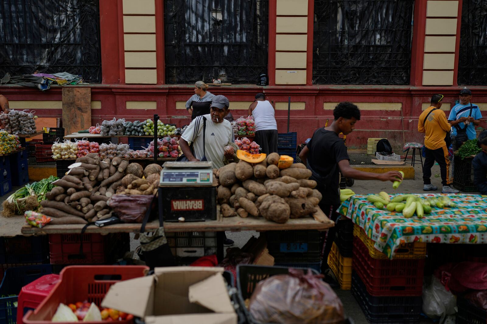 Vegetables sit for sale at a street market in Caracas, Venezuela, Friday, April 11, 2025. (AP Photo/Ariana Cubillos)