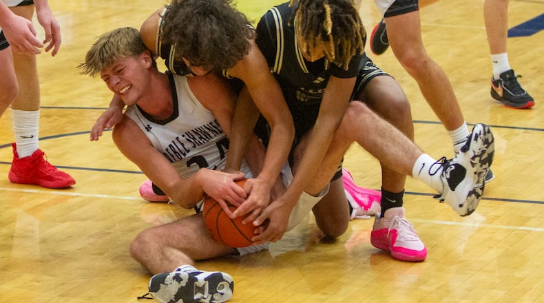 Preble Shawnee's Mason Shrout is tied up by two Lloyd Memorial players during Monday's opening game at Flyin' To The Hoop. Jeff Gilbert/CONTRIBUTED