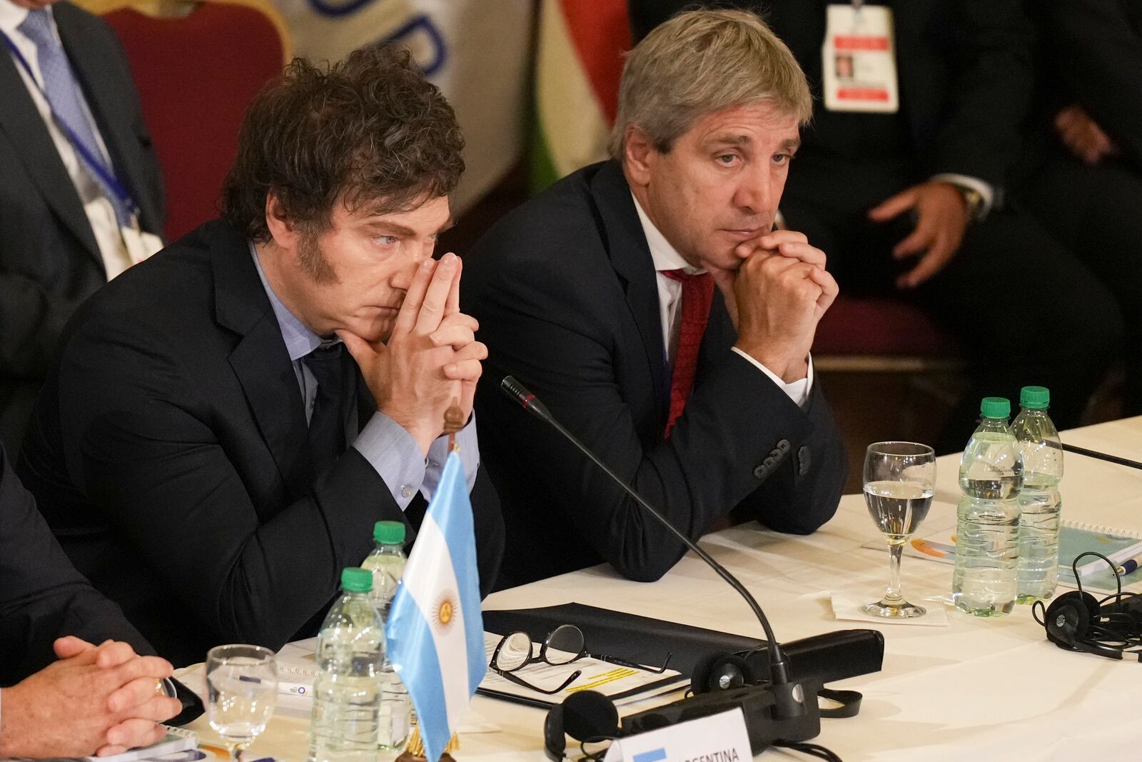 FILE - Argentina's President Javier Milei, left, and Economy Minister Luis Caputo attend the Mercosur Summit in Montevideo, Uruguay, Dec. 6, 2024. (AP Photo/Matilde Campodonico, File)