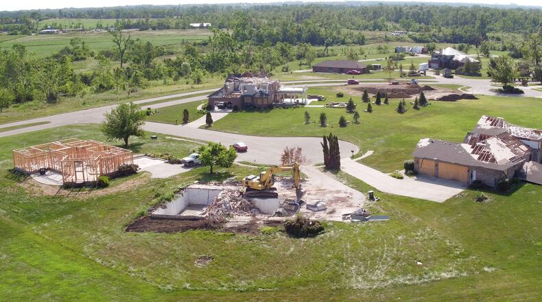 Almost every home in the Moss Creek development in Trotwood suffered some damage from the Memorial Day tornado. This view taken two months after the tornado shows homes that are actively being demolished, some awaiting settlement, one that has been stripped down to its frame and one that has been demolished and the lot graded. TY GREENLEES / STAFF