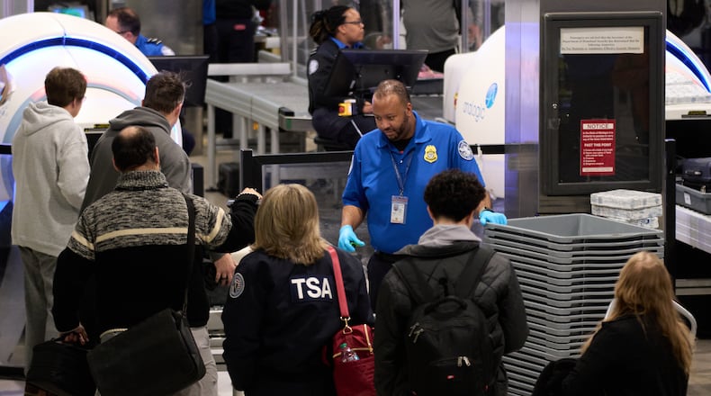 FILE - Travelers wait at a TSA security checkpoint at Detroit Metropolitan Wayne County Airport, Nov. 30, 2025, in Romulus, Mich. (AP Photo/Ryan Sun, File)