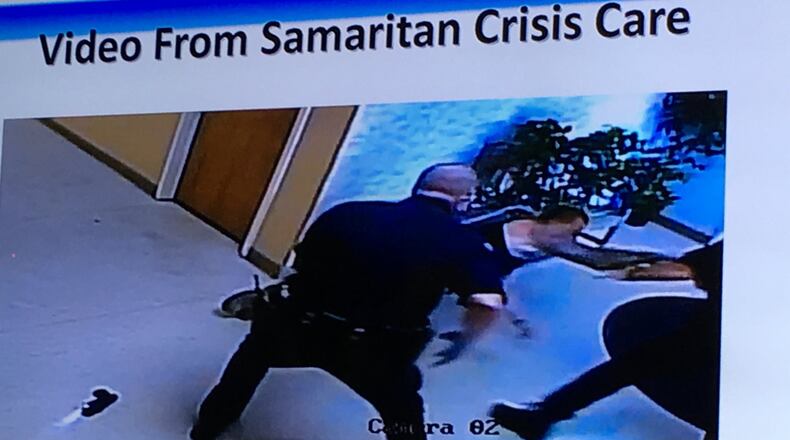 An image taken from surveillance footage shows Cory Fraley lunging toward a Dayton police officer on Sept. 3. Fraley was shot in the hip by an officer in the Samaritan Behavioral Health CrisisCare building.