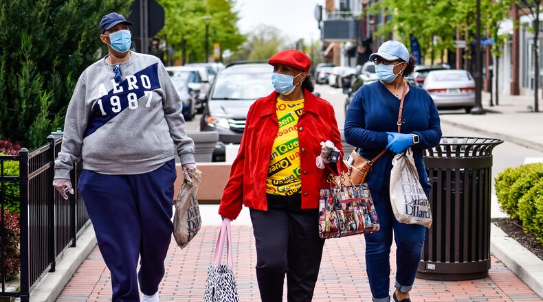 Joey Shields, left, Josephine Gates, middle, and Shelley Gates wear masks as they shop at Liberty Center in Liberty Township on the first day most retail stores were allowed to open Tuesday, May 12, 2020. NICK GRAHAM / STAFF