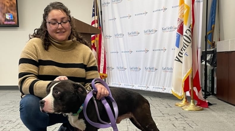 Montgomery County ARC Public Information Officer Kara Hamby pets Marty, a dog that's available for adoption at the shelter.