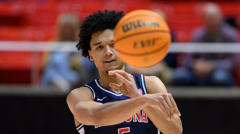 Arizona guard Brayden Burries passes during the second half of an NCAA college basketball game against Utah, Saturday, Jan. 3, 2026, in Salt Lake City. (AP Photo/Tyler Tate)