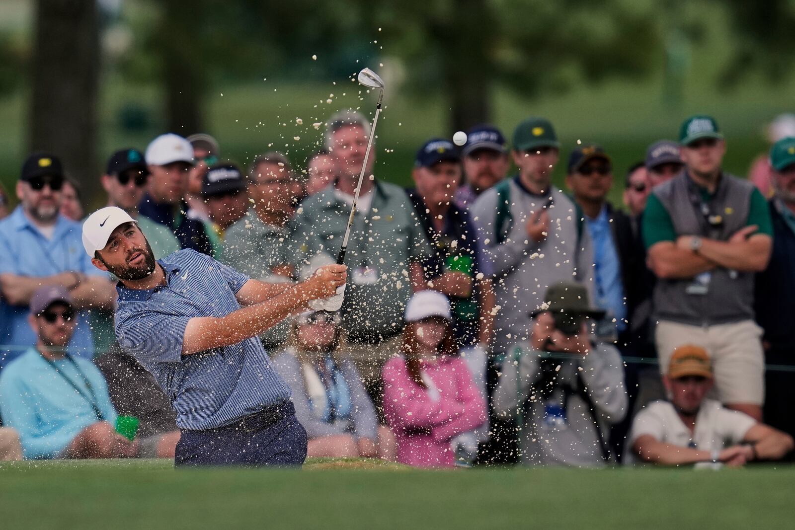 Scottie Scheffler hits from the bunker on the 15th hole during the second round at the Masters golf tournament, Friday, April 11, 2025, in Augusta, Ga. (AP Photo/David J. Phillip)