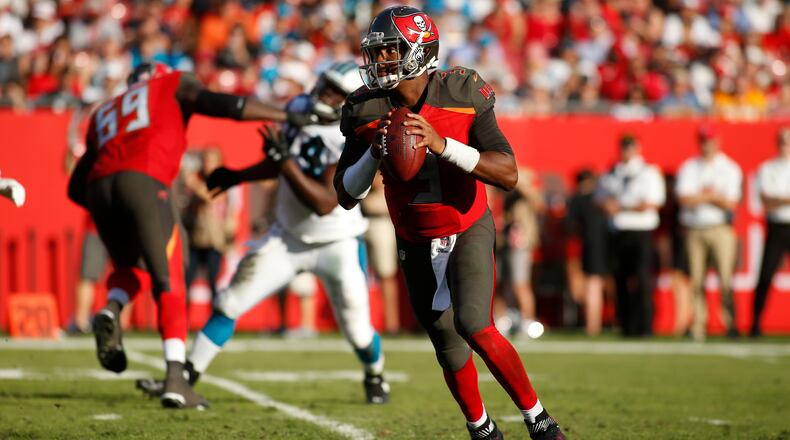 Quarterback Jameis Winston of the Buccaneers looks for an open receiver during a Jan. 1 game against the Panthers in Raymond James Stadium in Tampa.