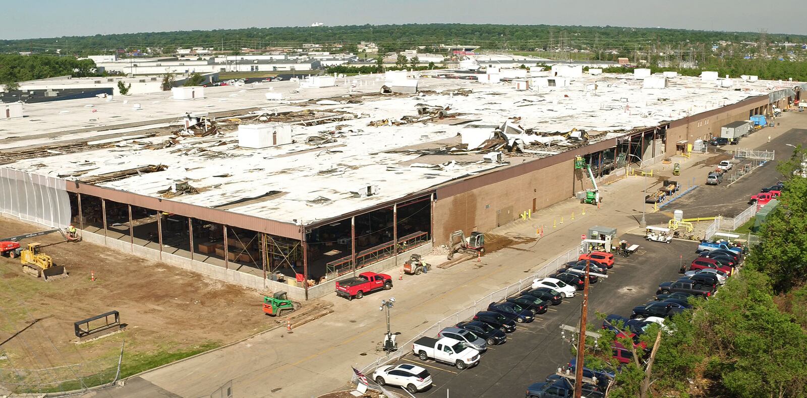 Aerial view looking northwest at the nearly 650,000 square foot Dayton Phoenix Group building on Kuntz Road in the Old North Dayton business park. The roof and walls were severely damaged  by a tornado on Memorial Day.Construction workers are beginning restoration work.  TY GREENLEES / STAFF