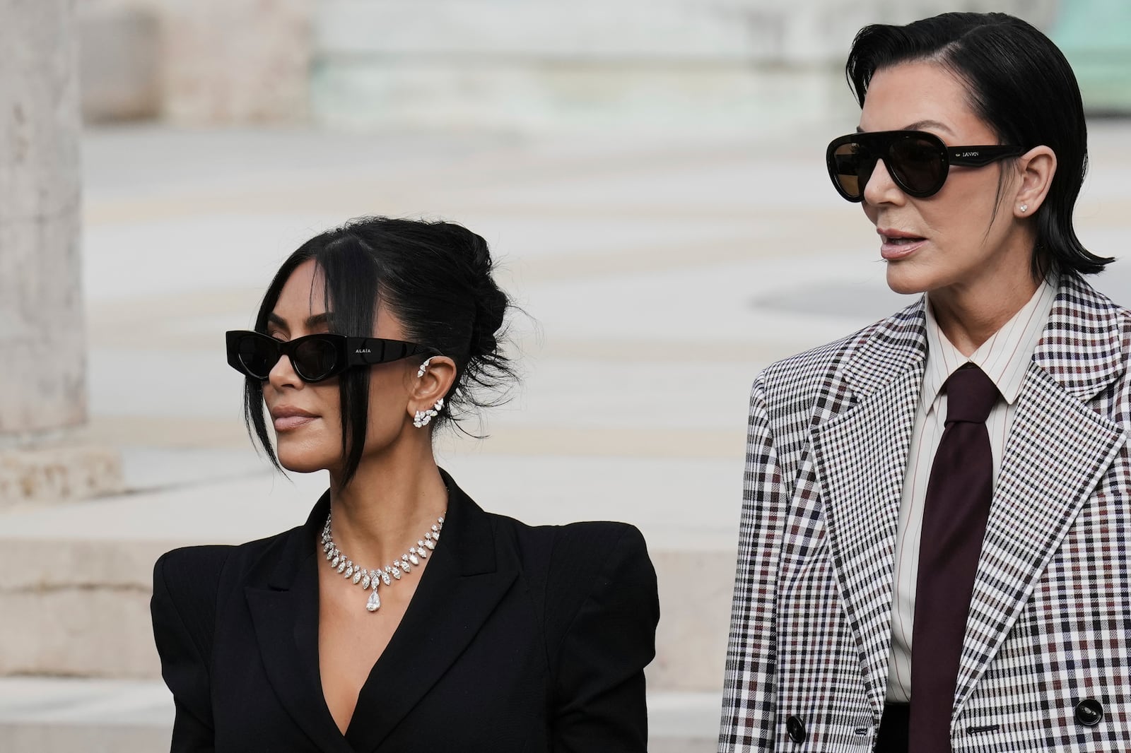 Kim Kardashian, left, accompanied by her mother Kris Jenner leaves the justice palace after testifying, regarding a robbery of millions of dollars in jewels from her Paris hotel room in 2016, in Paris, Tuesday, May 13, 2025. (AP Photo/Aurelien Morissard)