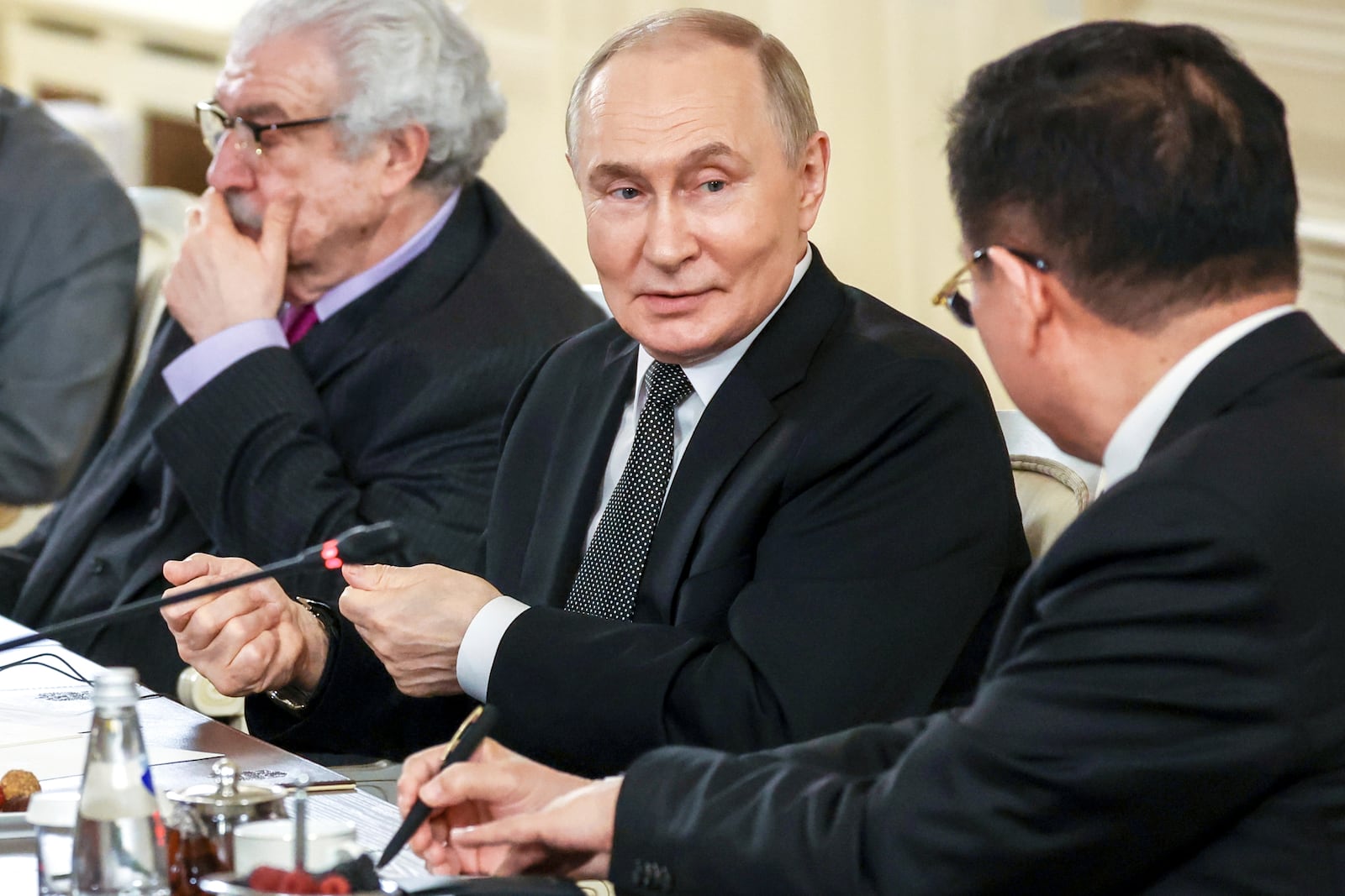 Russian President Vladimir Putin, center, speaks with Xinhua News Agency President Fu Hua, right, during his meeting with the heads of international news agencies at the newly renovated St. Petersburg Rimsky-Korsakov State Conservatory on the sidelines of the St. Petersburg International Economic Forum in St. Petersburg, Russia, Thursday, June 19, 2025. (Vyacheslav Prokofyev, Sputnik, Kremlin Pool Photo via AP)