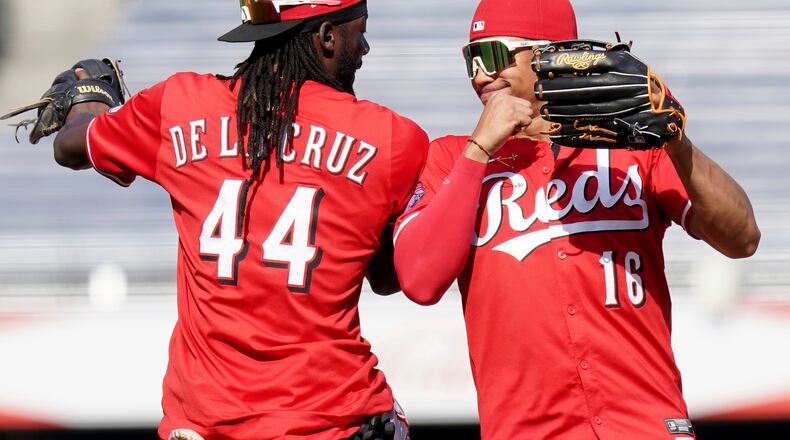 Cincinnati Reds shortstop Elly De La Cruz, left, celebrates with right fielder Noelvi Marte, right, after their team defeated the Pittsburgh Pirates in a baseball game Sunday, Aug. 10, 2025, in Pittsburgh. (AP Photo/Matt Freed)