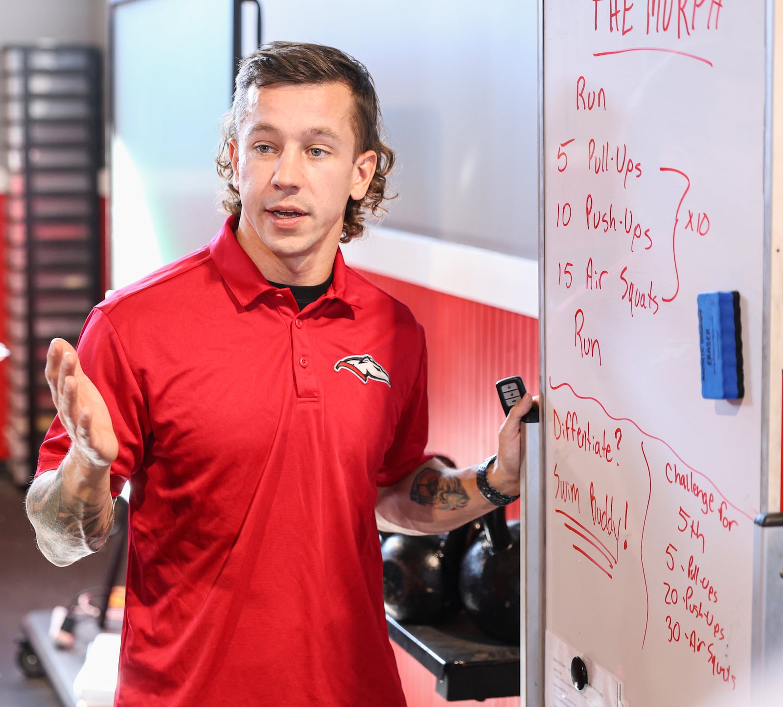 Dixie High School gym teacher Jonathon Hutchison goes over a workout plan during a weight training class on Wednesday, Nov. 5 in the school's weight room facility in New Lebanon. The students in class did a "Murph," workout in class, in honor of Navy Lieutenant Michael Murphy, who died in Afghanistan in 2005. BRYANT BILLING/STAFF