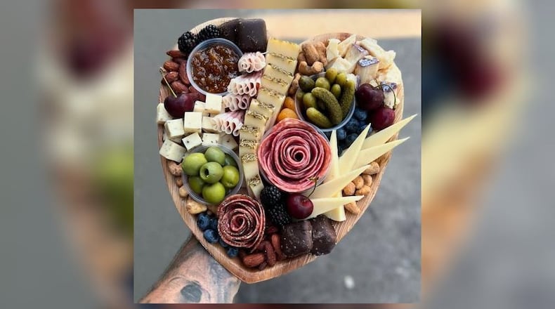 The heart-shaped charcuterie board by A Pretty Picnic have a variety of specialty meats, gourmet cheeses, fresh fruits, snack nuts, sweet treats and house-made jams. CONTRIBUTED