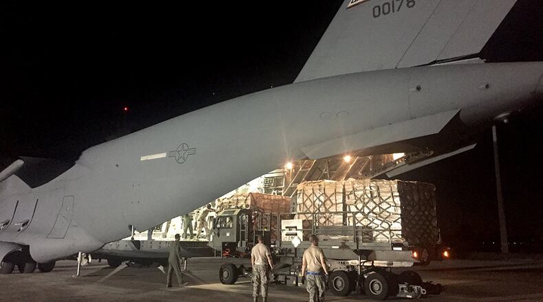 A Wright-Patterson Air Force Reserve C-17 crew unloads hurricane relief supplies at Homestead Air Reserve Base in Florida on Sept. 12, 2017. BOB GARLOCK / STAFF