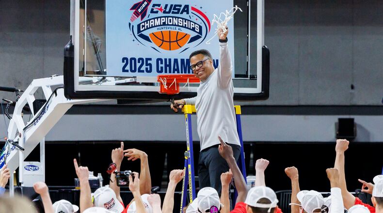 Liberty head coach Ritchie McKay, top, celebrates as he cuts down the second net after a win in an NCAA college basketball game against Jacksonville State in the championship of the Conference USA tournament Saturday, March 15, 2025, in Huntsville, Ala. (AP Photo/Vasha Hunt)