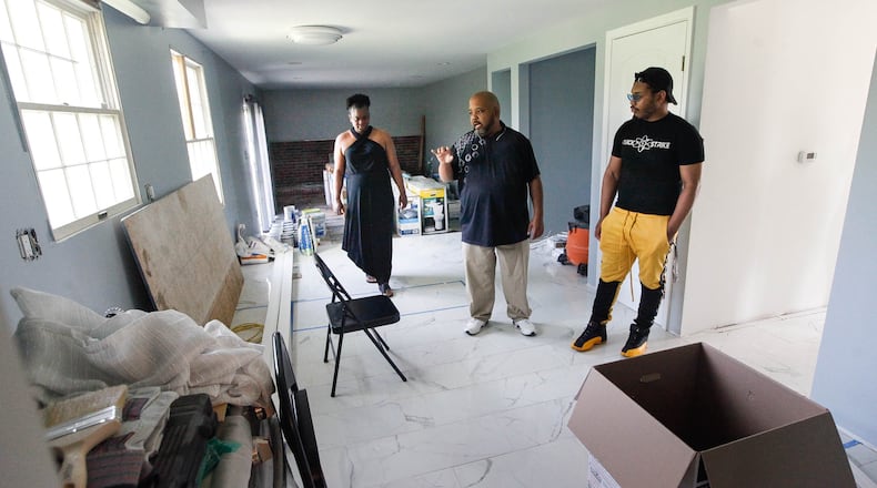 Due to insurance and contractor problems, Kandace and Derrick Stephens, pictured with their son Darius, are still waiting to move back into their Greenbrook Drive home in Trotwood two years after 2019 Memorial Day tornadoes hit the region. CHRIS STEWART / STAFF