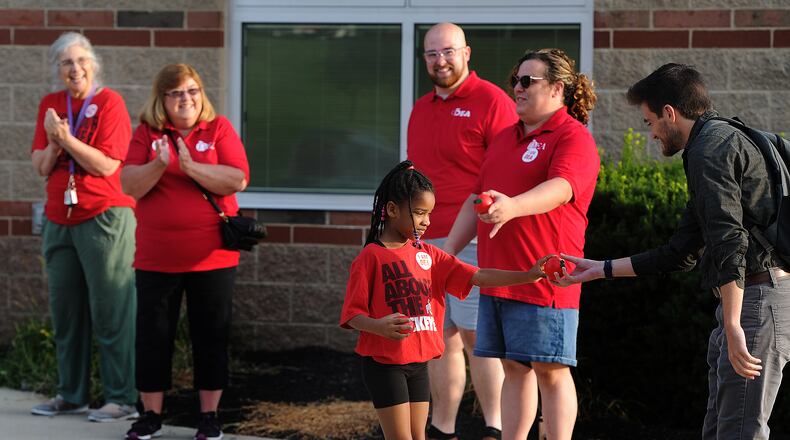 Kaliyah Williams, age 6, helps the Dayton teachers union members clap in first year teachers Thursday, Aug. 3, 2023 at Thurgood Marshall High School. MARSHALL GORBY\STAFF