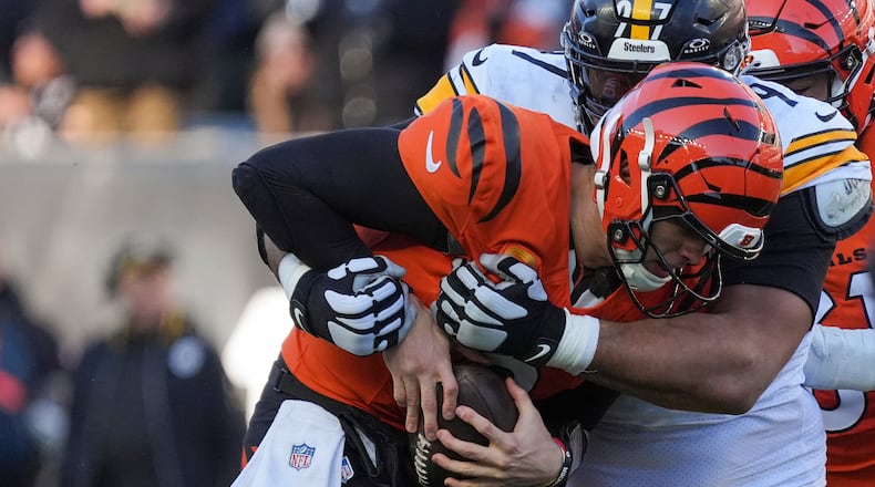 Pittsburgh Steelers defensive tackle Cameron Heyward, right, sacks Cincinnati Bengals quarterback Joe Burrow during the second half of an NFL football game Sunday, Dec. 1, 2024, in Cincinnati. (AP Photo/Joshua A. Bickel)