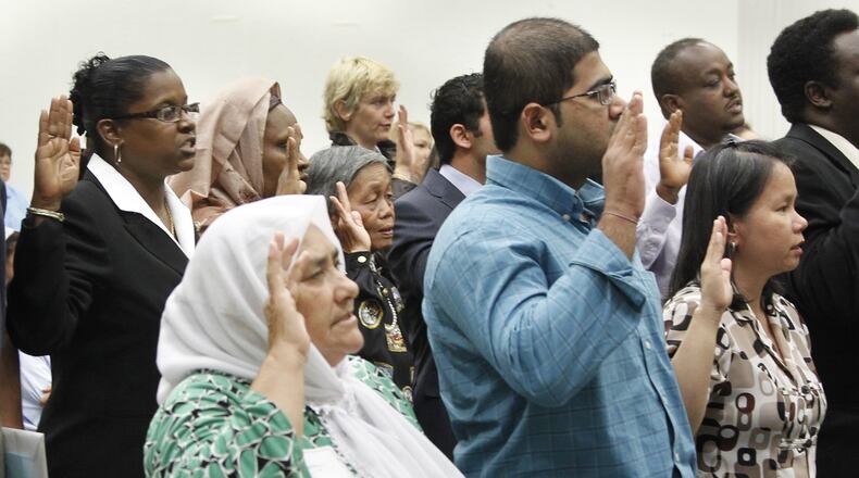 A swearing-in ceremony for new U.S. citizens is scheduled Thursday morning at Oakwood High School. The photo above included 90 people from 40 different countries taking the oath of citizenship from U.S. District Judge Walter H. Rice in 2020. STAFF PHOTO BY CHRIS STEWART