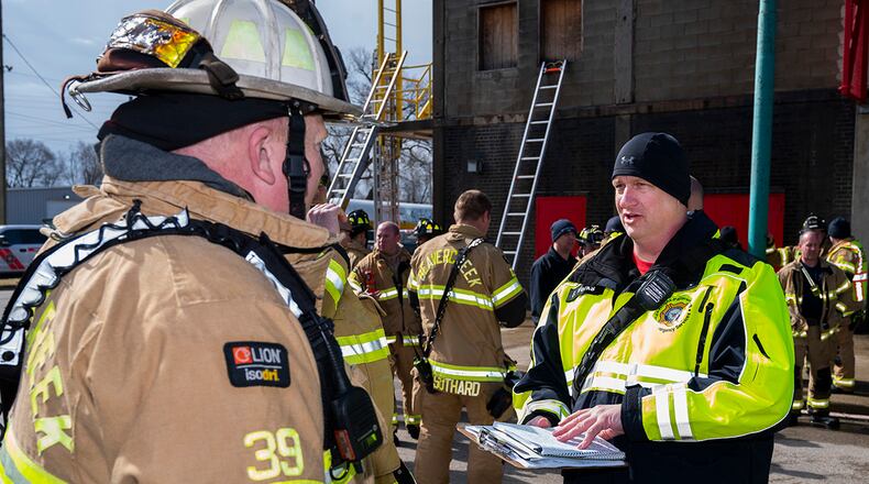 Assistant Chief Bryan Weeks (right), Wright-Patterson Air Force Base Fire Department, debriefs Division Chief Scott Dorsten, Beavercreek Township Fire Department, following a training exercise on March 3 at the Dayton Fire Training Center. The Beavercreek and Wright-Patterson departments are mutual-aid partners, lending each other a hand when needed. U.S. AIR FORCE PHOTO/R.J. ORIEZ