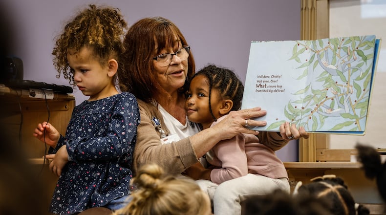 Hope Center kindergarten readiness teacher, Michelle Kreitzer reads Two Little Monkeys to her class at the Hope Center Wednesday October 19, 2022. The center has submitted an application to the U.S. Department of Education requesting about $30 million in funding to expand its programs to other Dayton neighborhoods. The program will help improve academic and developmental outcomes for children living in communities of concentrated poverty. JIM NOELKER/STAFF