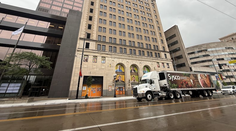 A tractor trailer drives by 34 N. Main St. in downtown Dayton. CORNELIUS FROLIK / STAFF