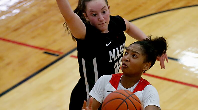 Lakota West High School guard Chance Gray goes up to score against Mason guard Margo Mattes during a Greater Miami Conference basketball game in West Chester Jan. 23, 2021. Contributed photo by E.L. Hubbard