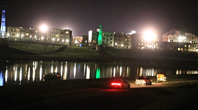 Dayton police and fire crews were called to the Great Miami River, off Webster Street in Deeds Park, for this car into the water on Monday night, Aug. 22, 2016. (Jim Noelker/Staff)