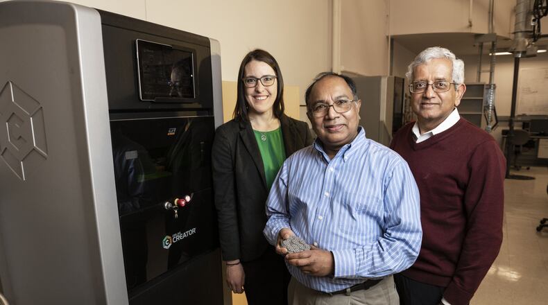 From left: Wright State University Department of Mechanical and Materials Engineering faculty members Joy Gockel, Ahsan Mian and Raghu Srinivasan stand beside the ORLAS Creator 3D printer. Photo by Erin Pence