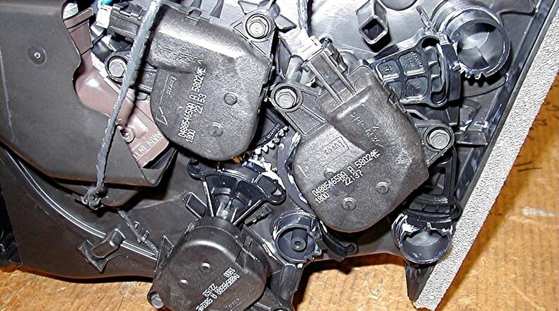 Three electrical actuators on the side of the HVAC case after it has been removed from the vehicle. While these actuators can usually be replaced without removing the entire heating and air conditioning module assembly from the vehicle, it is a job for a professional service technician. James Halderman photo