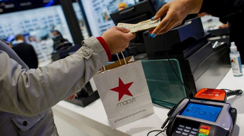 An employee rings up a customer at the Macy’s Inc. flagship store in New York, U.S., on Tuesday, Nov. 12, 2013. Macy’s Inc. is scheduled to release earnings figures on Nov. 13. Photographer: Ron Antonelli/Bloomberg