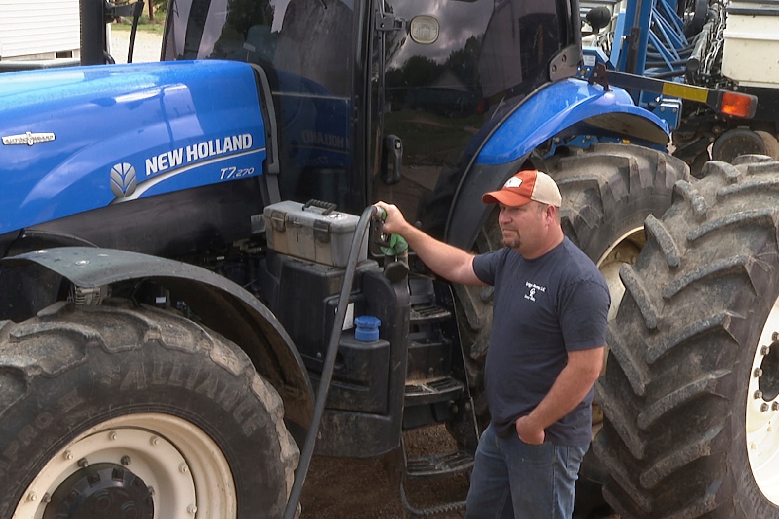 In this image from video, Matt Griggs fills up his tractor with fuel on Monday, May 5, 2025 at his farm in Humboldt, Tenn. Griggs, like many American farmers, is paying close attention to the trade war between the U.S. and China, a critical market for soybeans. (AP photo/Kristin M. Hall)