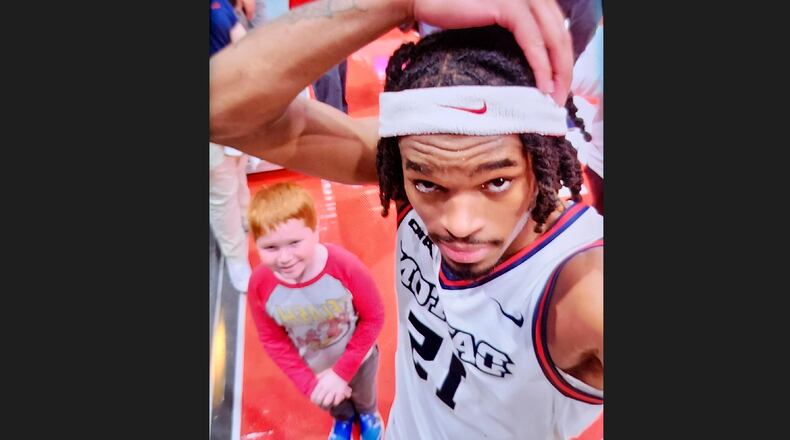 Dayton's DaRon Holmes II poses for a photo with UD fan Duncan Zobrist, 10, after a game against Longwood on Saturday, Dec. 30, 2023, at UD Arena. Contributed photo