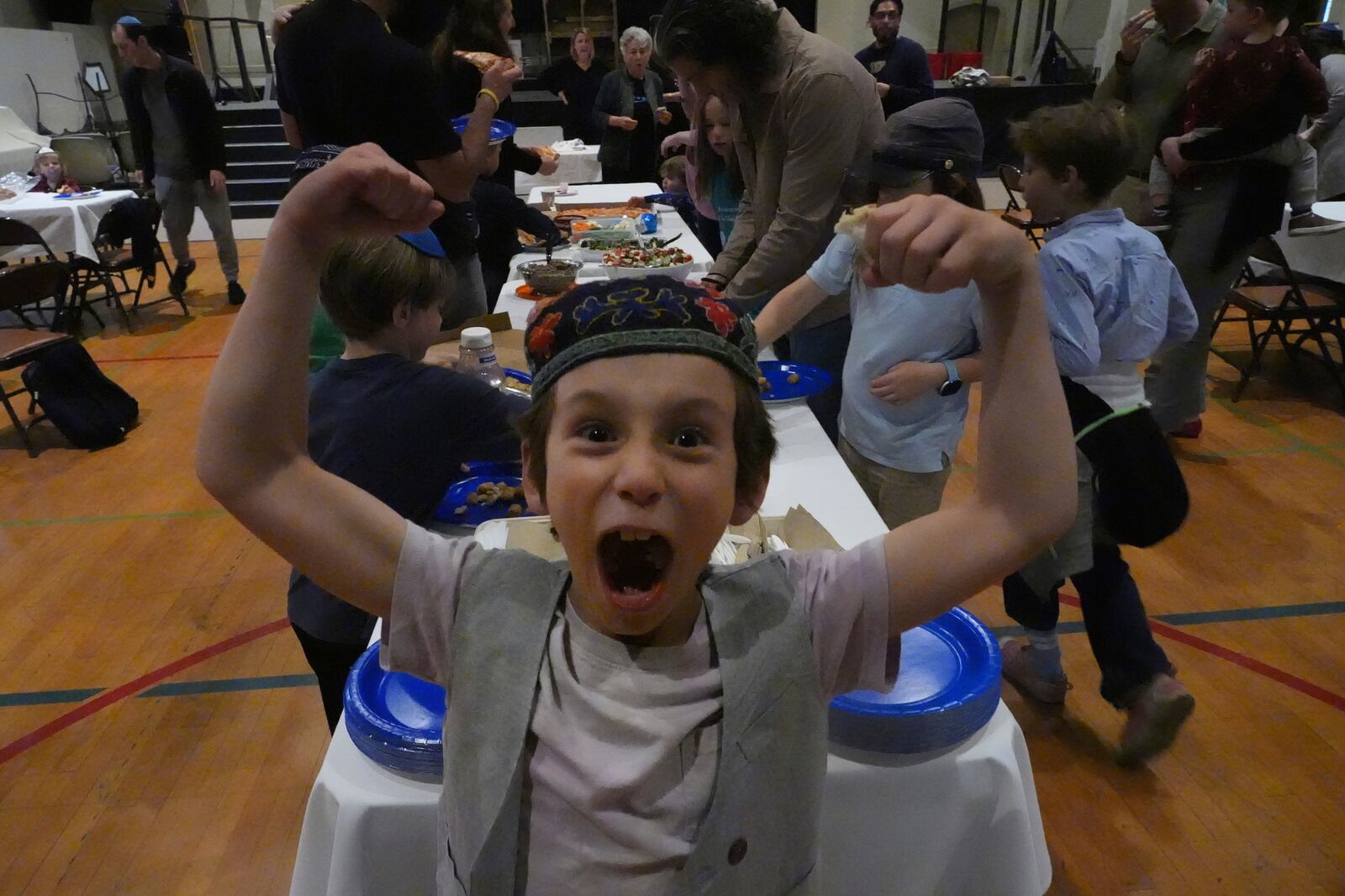 Congregants of the 104-year-old Pasadena Jewish Temple and Center which burned down in the Jan. 2025 Eaton fire, gathered for a potluck doing the Passover celebrations at the First United Methodist Church in Pasadena, Calif. on Friday, April 4, 2025. (AP Photo/Damian Dovarganes)